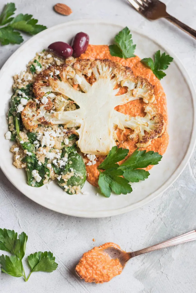Cauliflower Steaks with Roasted Red Pepper Sauce, Spinach and Goat Cheese